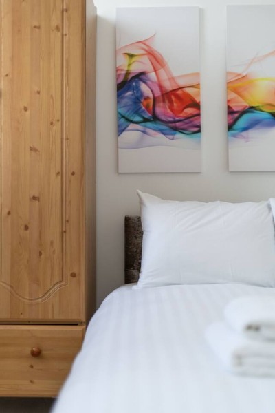 This home on Uxbridge Road, Greater London, features a cozy bedroom with a comfy bed, soft lighting, and relaxing vibes, ideal for rest after a long day.