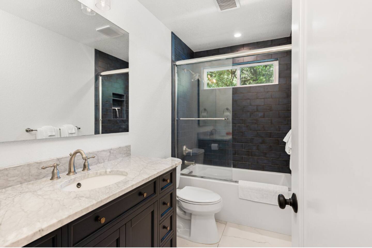 Pamper yourself in the sleek bathroom, featuring a bathtub for a soothing soak.