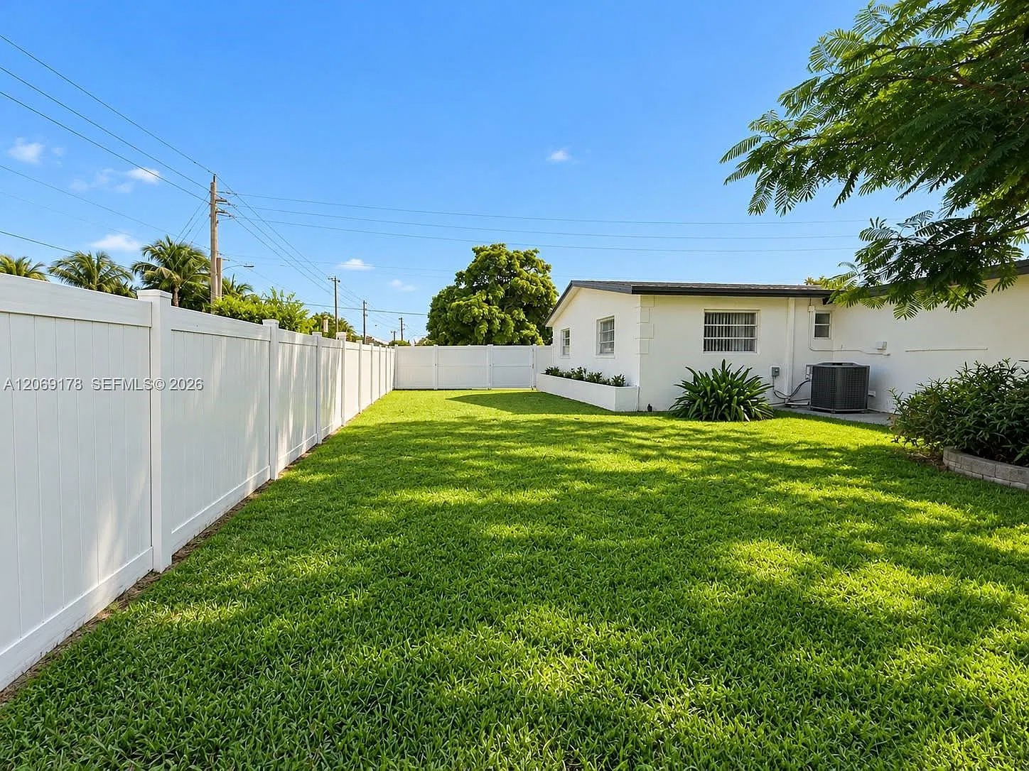 Spacious fenced backyard with lush lawn and plenty of room to unwind