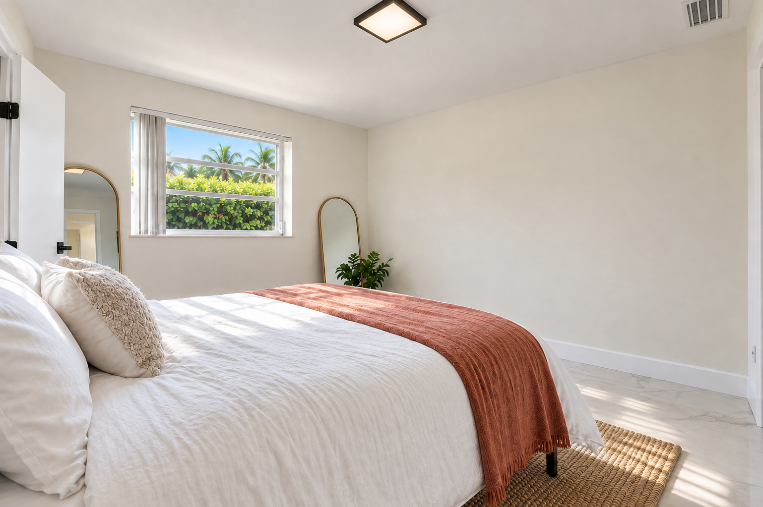 Bright, cozy bedroom with natural light and tropical garden views
