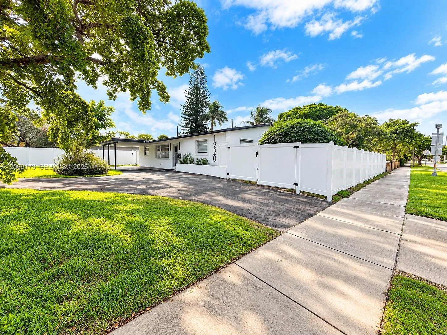 Bright single-story home with private fenced yard and lush curb appeal