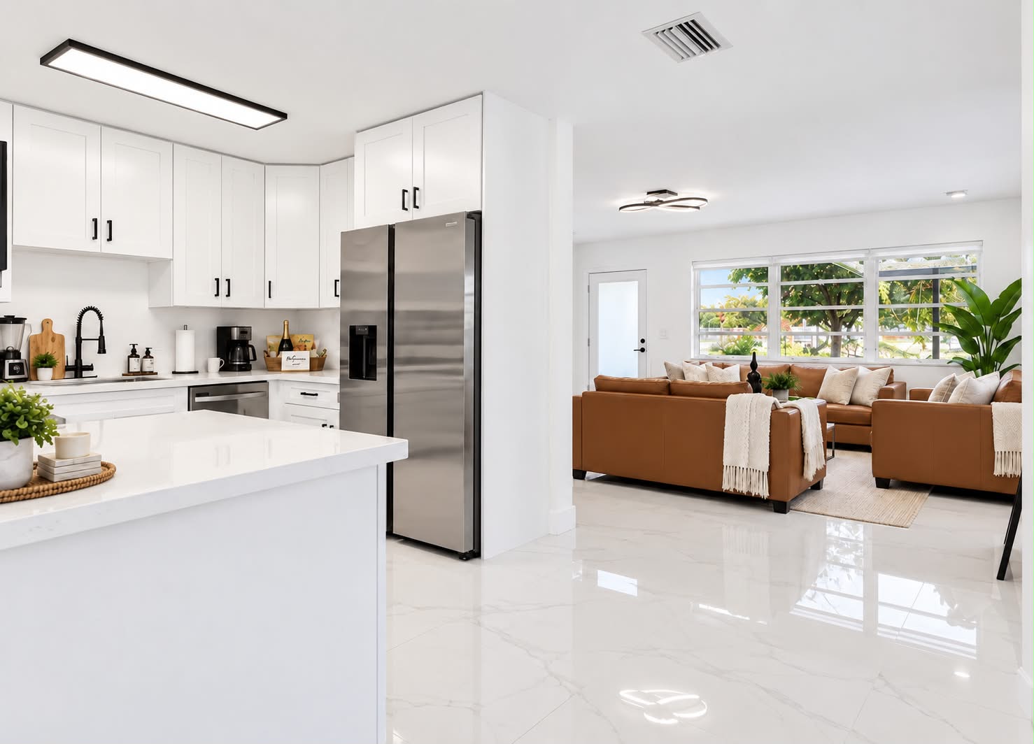 Bright open-concept kitchen and lounge with sleek modern finishes
