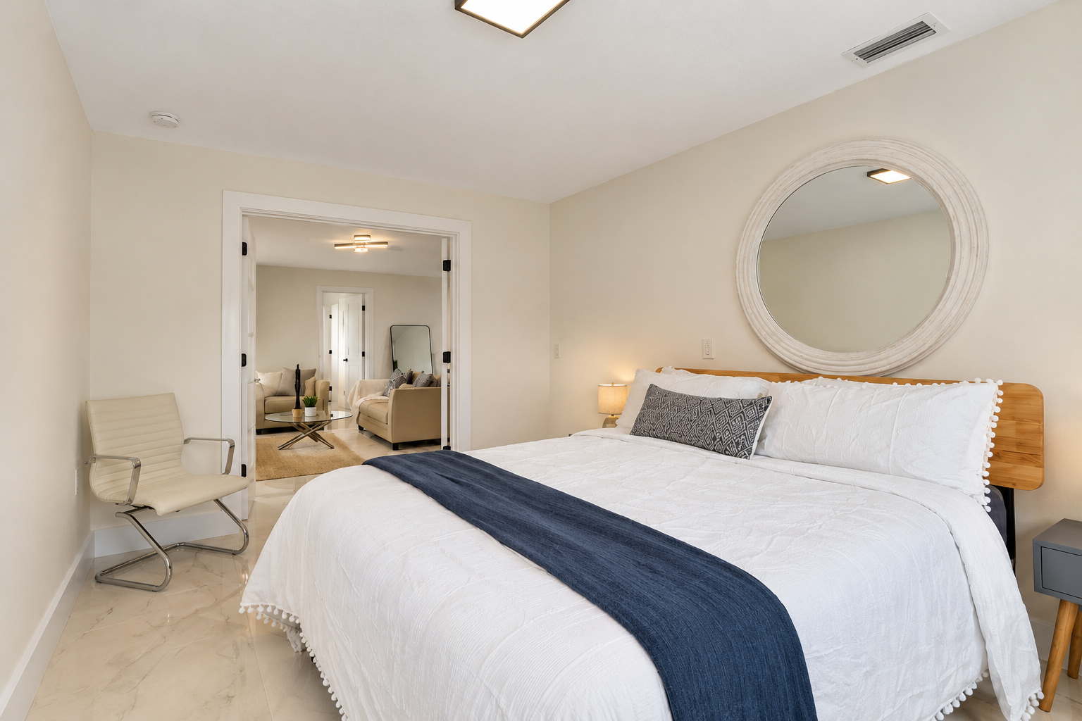 Bright modern bedroom with plush king bed and adjoining sitting area