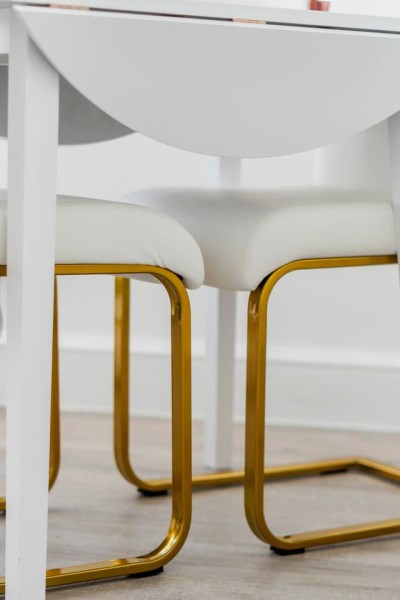 Located in Greater London close to Notting Hill, Acton & Ealing, this space features a cozy dining spot with white chairs, wide windows, a modern clock, and a microwave for quick meals.