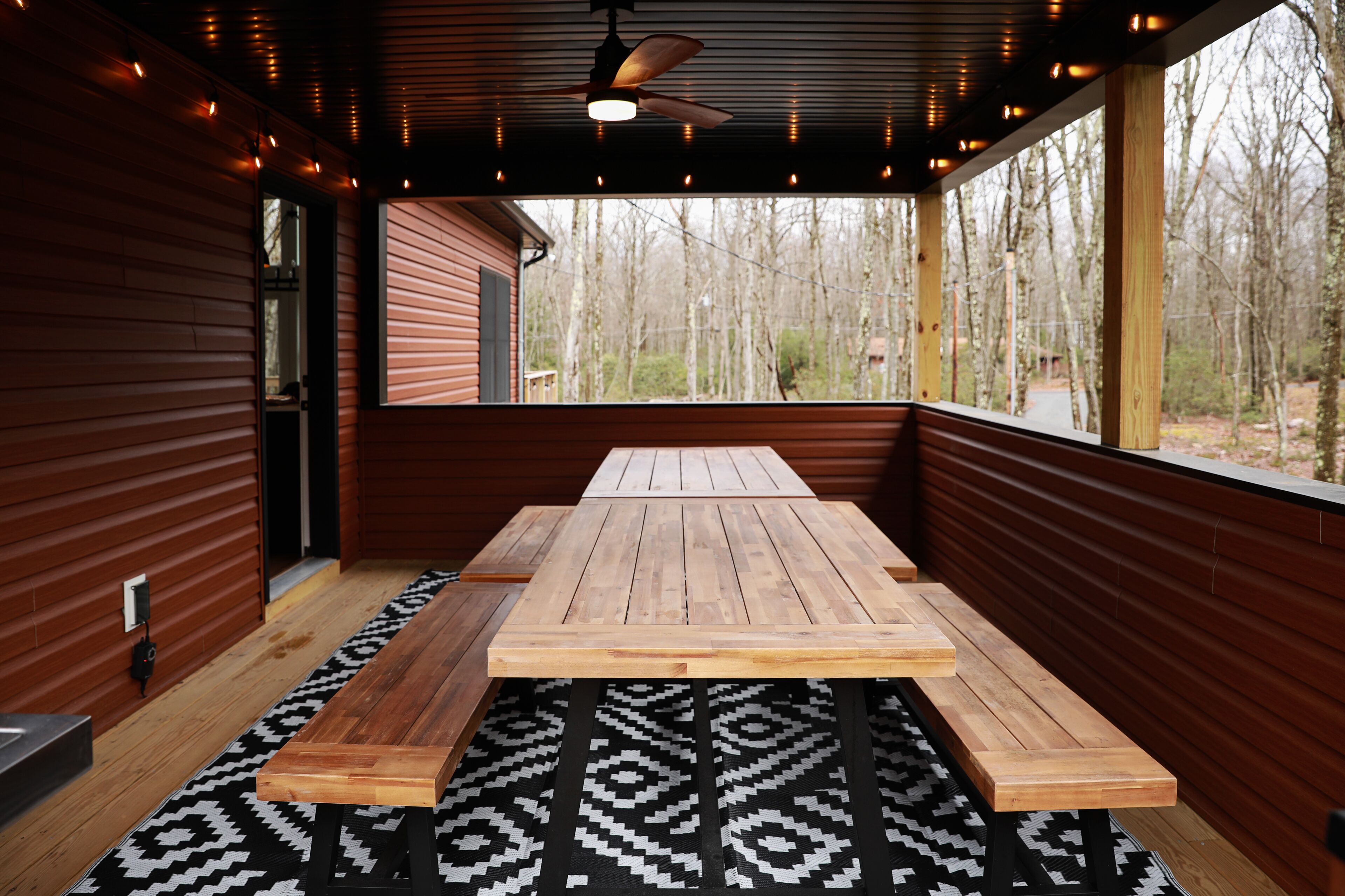 Ample seating in covered deck area for outdoor dining.