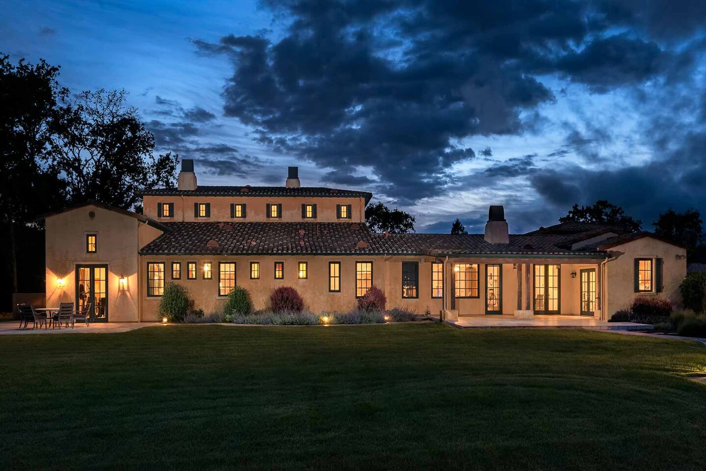 A breathtaking view at night, with its warm, golden glow. The property transforms into a tranquil and enchanting nighttime retreat