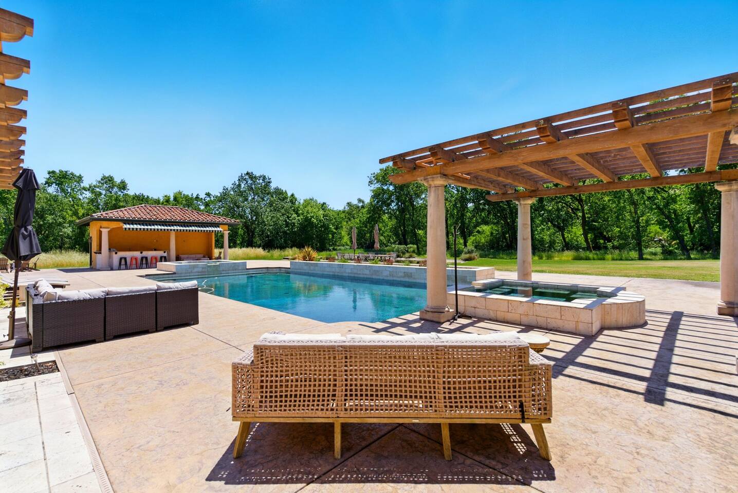 Enjoy a refreshing plunge in the outdoor spa and pool, all while being surrounded by nature.