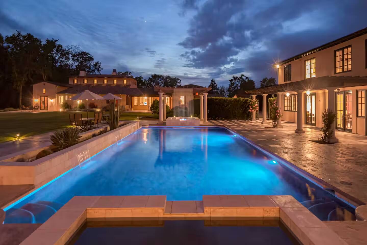 Relax and unwind in the stunning outdoor pool, perfectly illuminated and surreal under the evening sky. A tranquil escape with beautiful views, ideal for evening swims or simply soaking in the serene atmosphere.