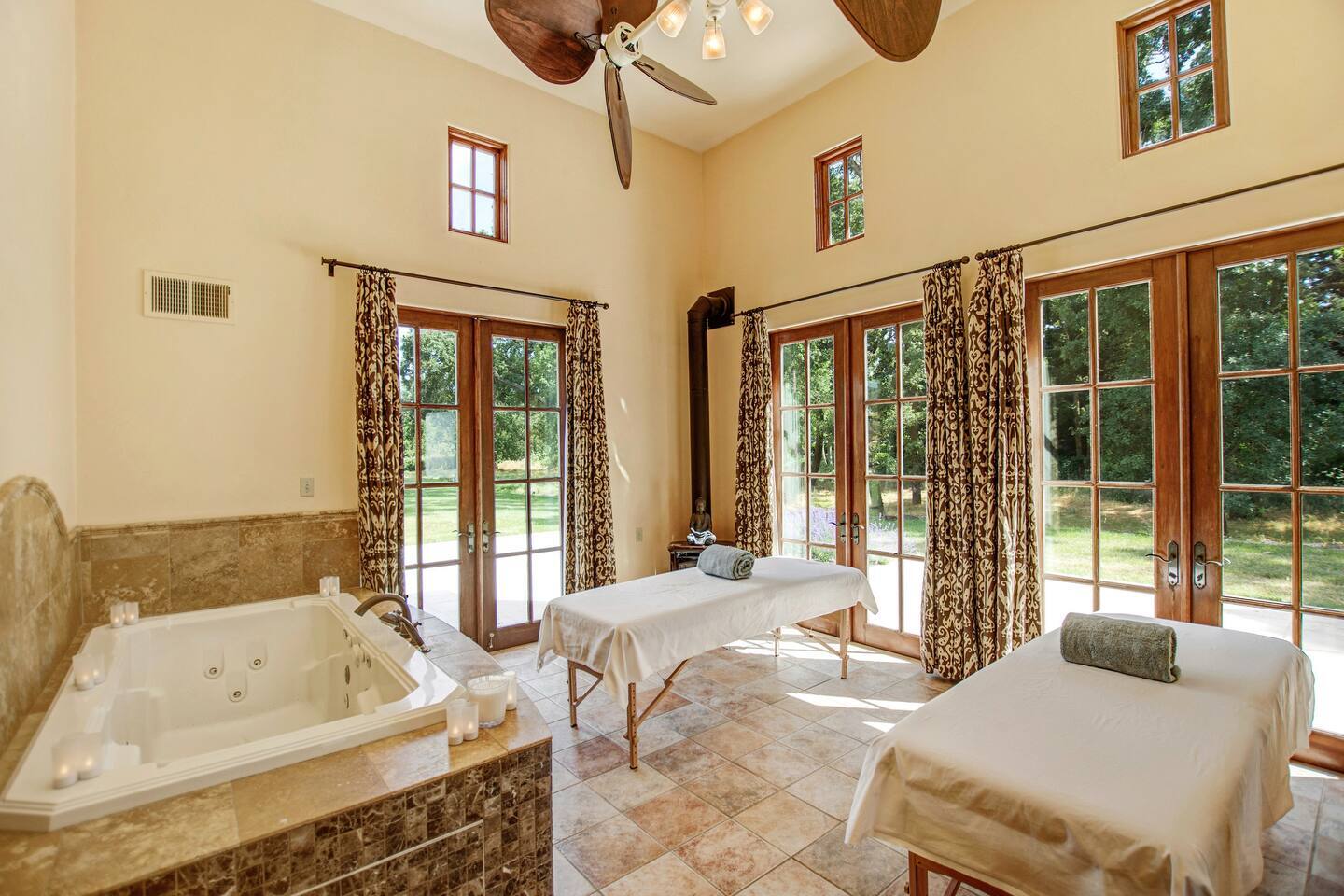 An indoor spa room designed for ultimate relaxation, featuring a soothing hot tub and massage beds, this room offers a  perfect retreat for unwinding with your loved ones.