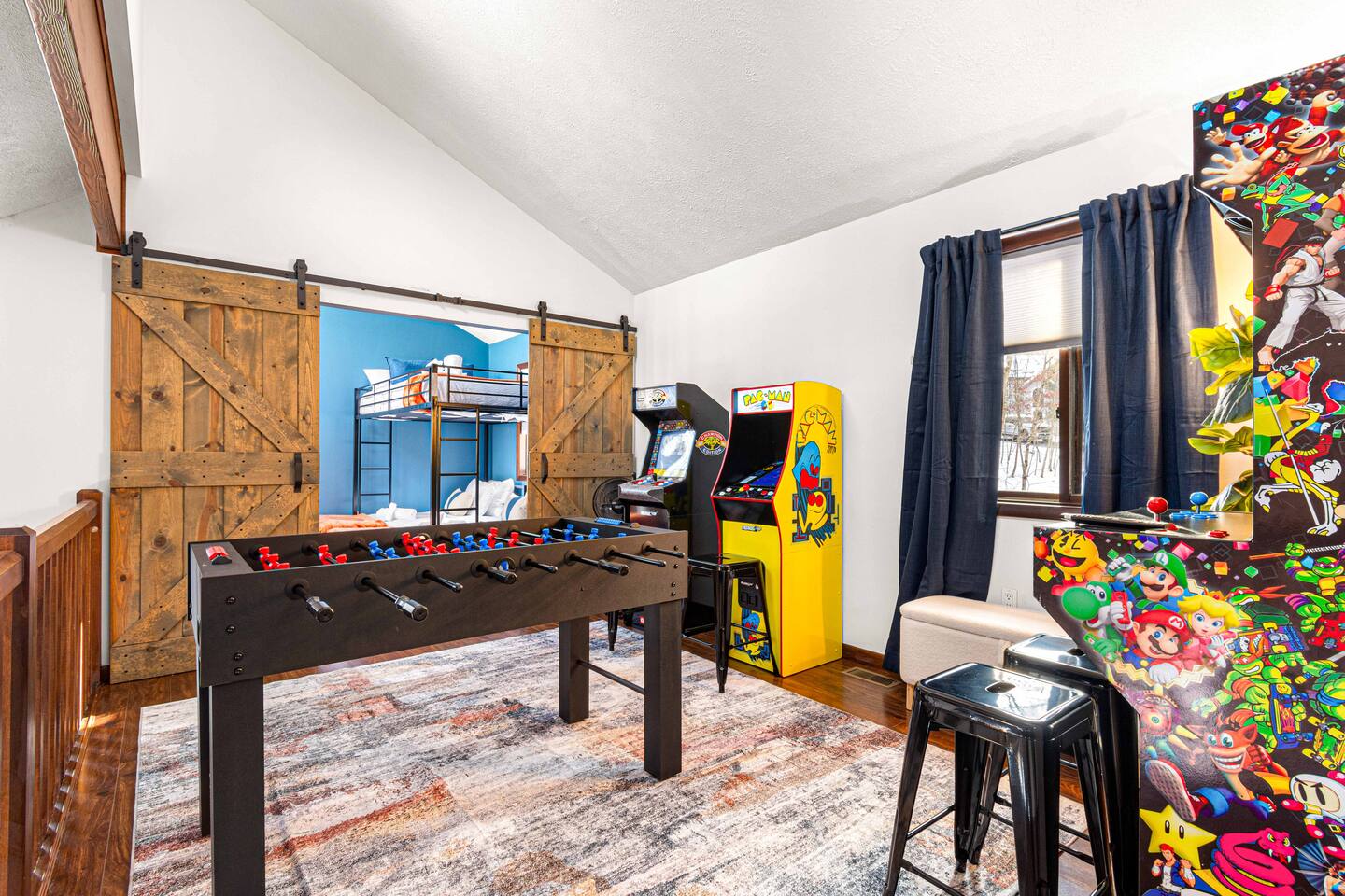 Game room with foosball and arcade machines at Highland Lake Retreat