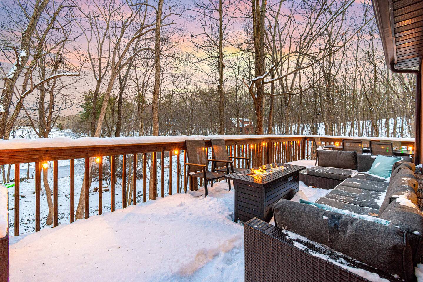 Expansive deck with a gas fire pit overlooking the lake