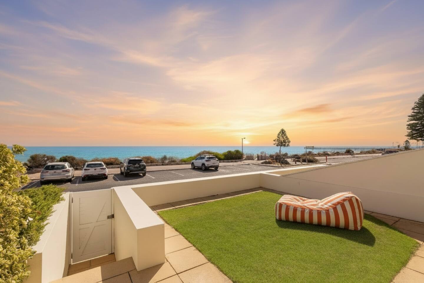 Cushioned loungers on the private front lawn with ocean views