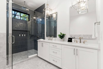 Luxury Primary Full Bathroom!  This spacious features a large soaking tub and a separate walk-in glass shower. Enjoy the double vanity with white counters and a dedicated makeup area. Vaulted ceilings complete this relaxing, spa-like retreat!