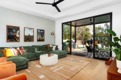 Sleek & Stylish Living Room! ️ Relax in the spacious green sectional sofa and enjoy the floor-to-ceiling sliding glass doors that open to the backyard. Features a large Smart TV, chic round coffee table, and unique art. 