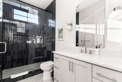 Spacious Walk-In Shower Ensuite! ✨ This modern full bathroom boasts a huge walk-in shower with a glass door, custom tile, and seating bench. Features a double vanity with plenty of counter space.