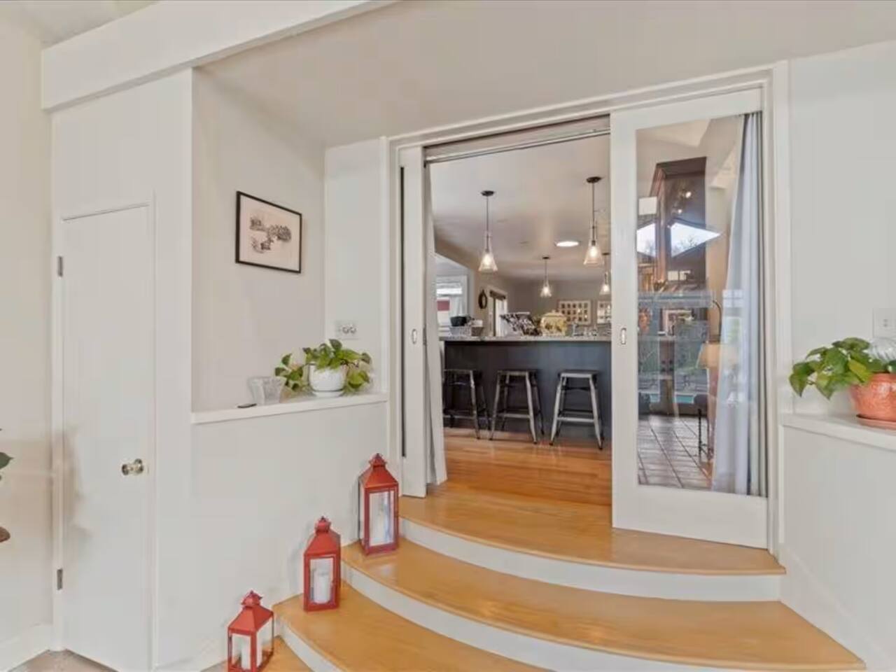 Step into the light-filled great living room from the kitchen, where natural light floods the space, creating a warm and inviting atmosphere.