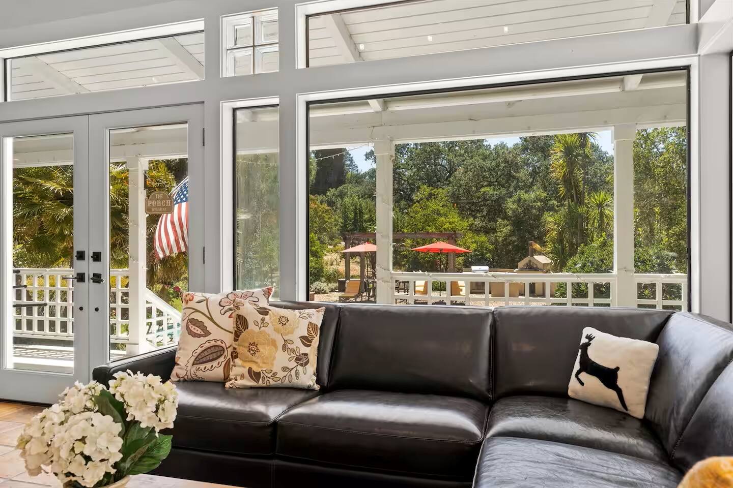 Unwind in style on the luxurious leather sofa,  where you can relax in style while the serene pool views unfold just beyond the large windows.