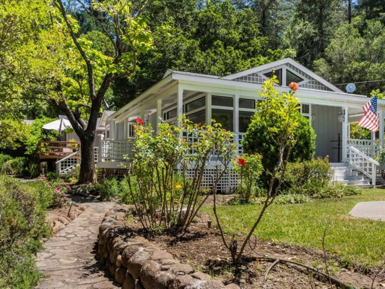 As you approach the home, vibrant blooms greet you, adding a burst of color and warmth to your arrival.