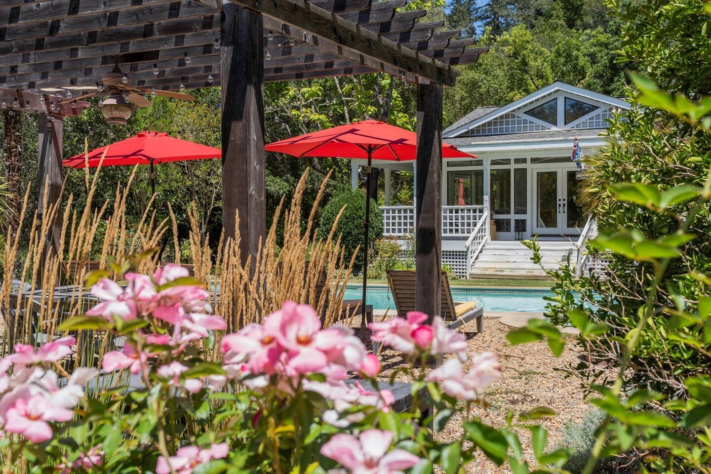 The home is surrounded by vibrant blooms, creating a colorful and cheerful atmosphere all around.