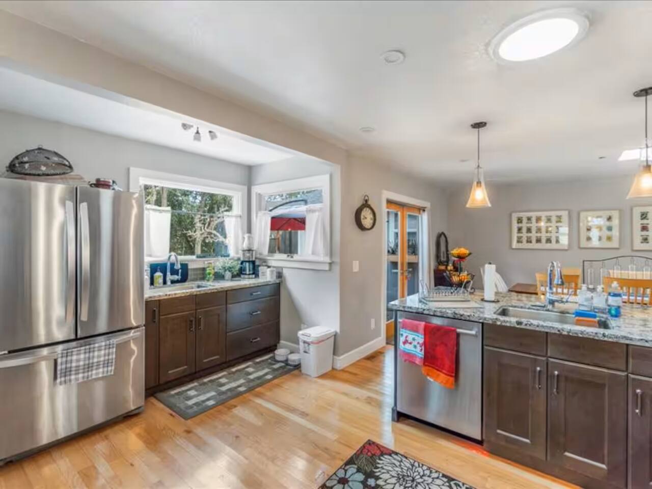 The fully equipped kitchen features a spacious full-sized refrigerator with a bottom freezer, a dishwasher, and dual sinks, everything you need for ultimate convenience during your stay!