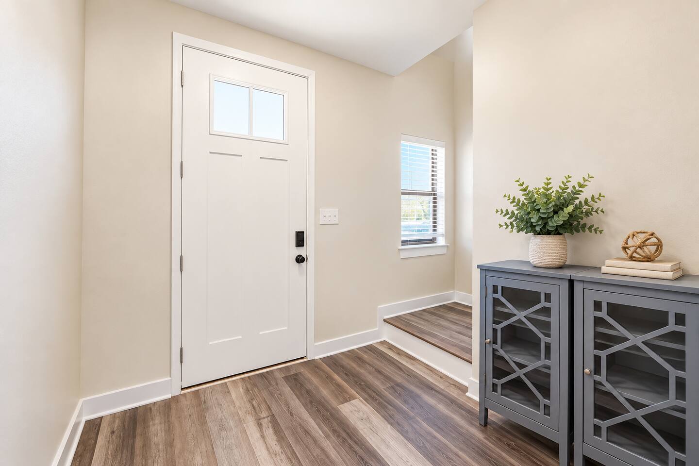 Featuring a sleek design and enhanced security, the front door of this townhouse ensures both style and peace of mind.