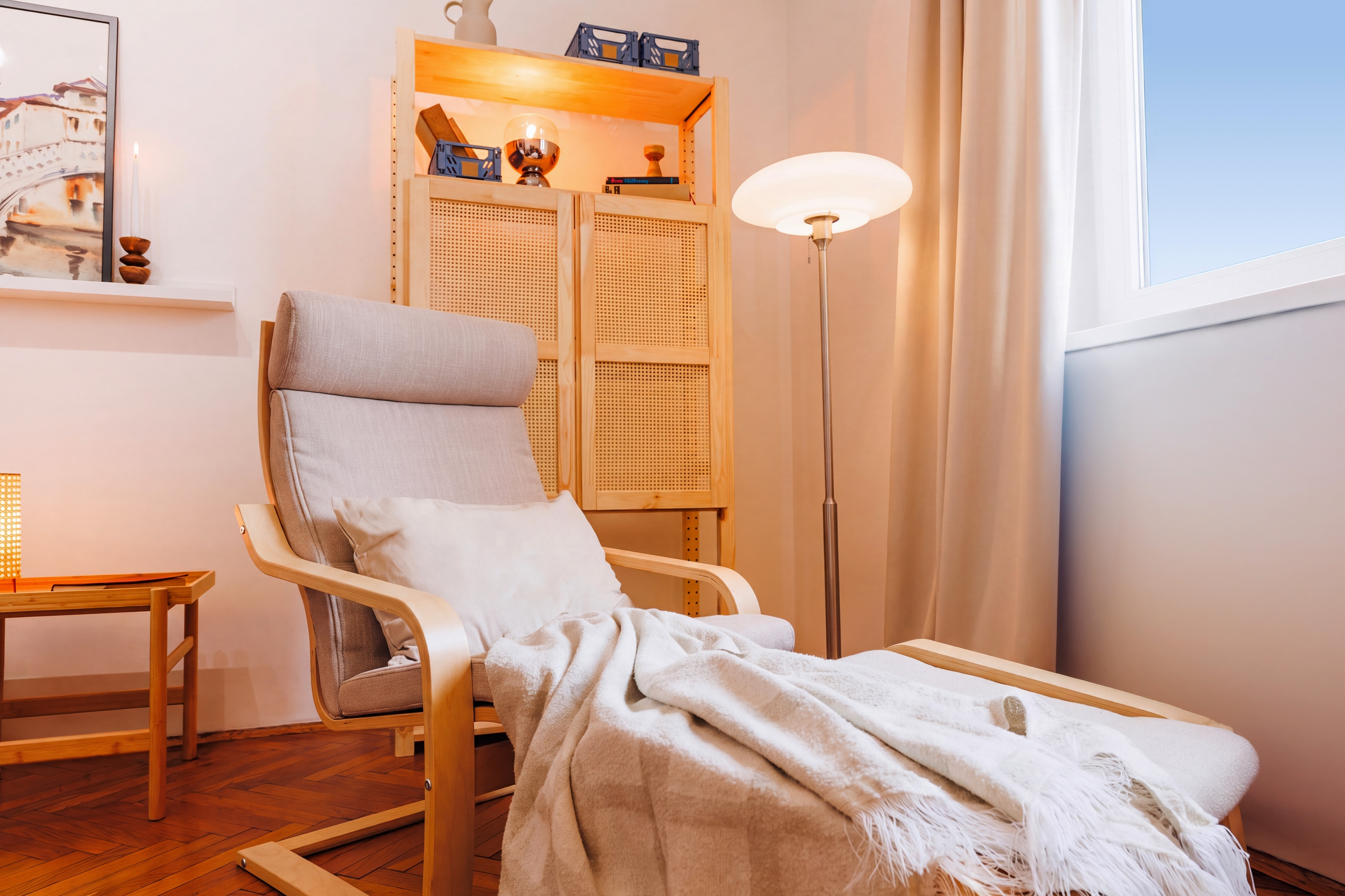 Cozy reading nook with lounge chair, soft lighting, and warm wood accents