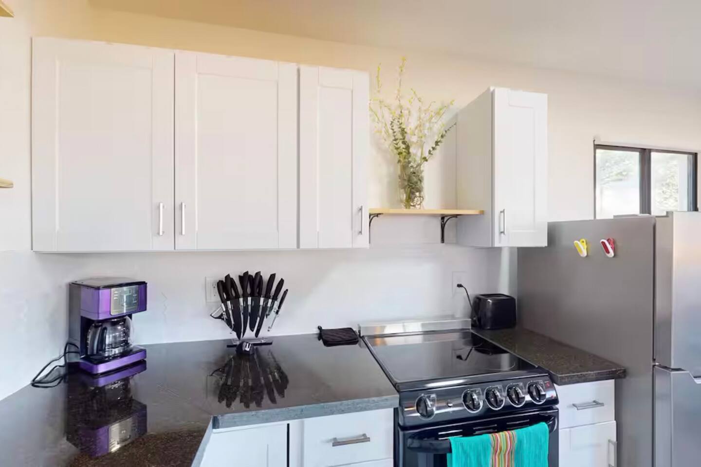 Bright modern kitchen with stainless appliances and coffee station