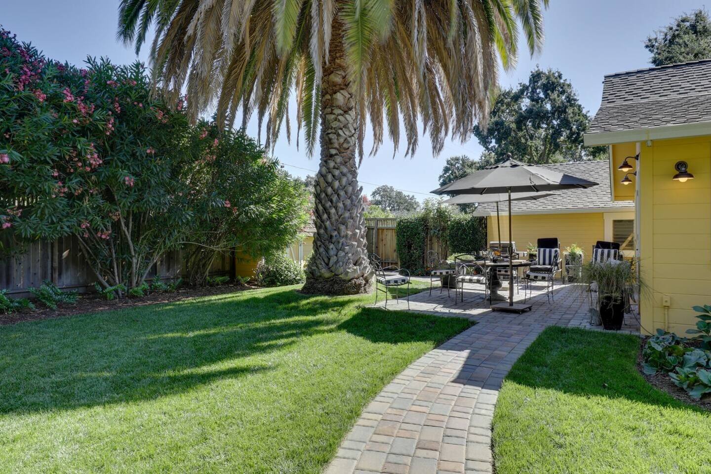 Enjoy alfresco dining in this charming garden seating area, surrounded by nature.