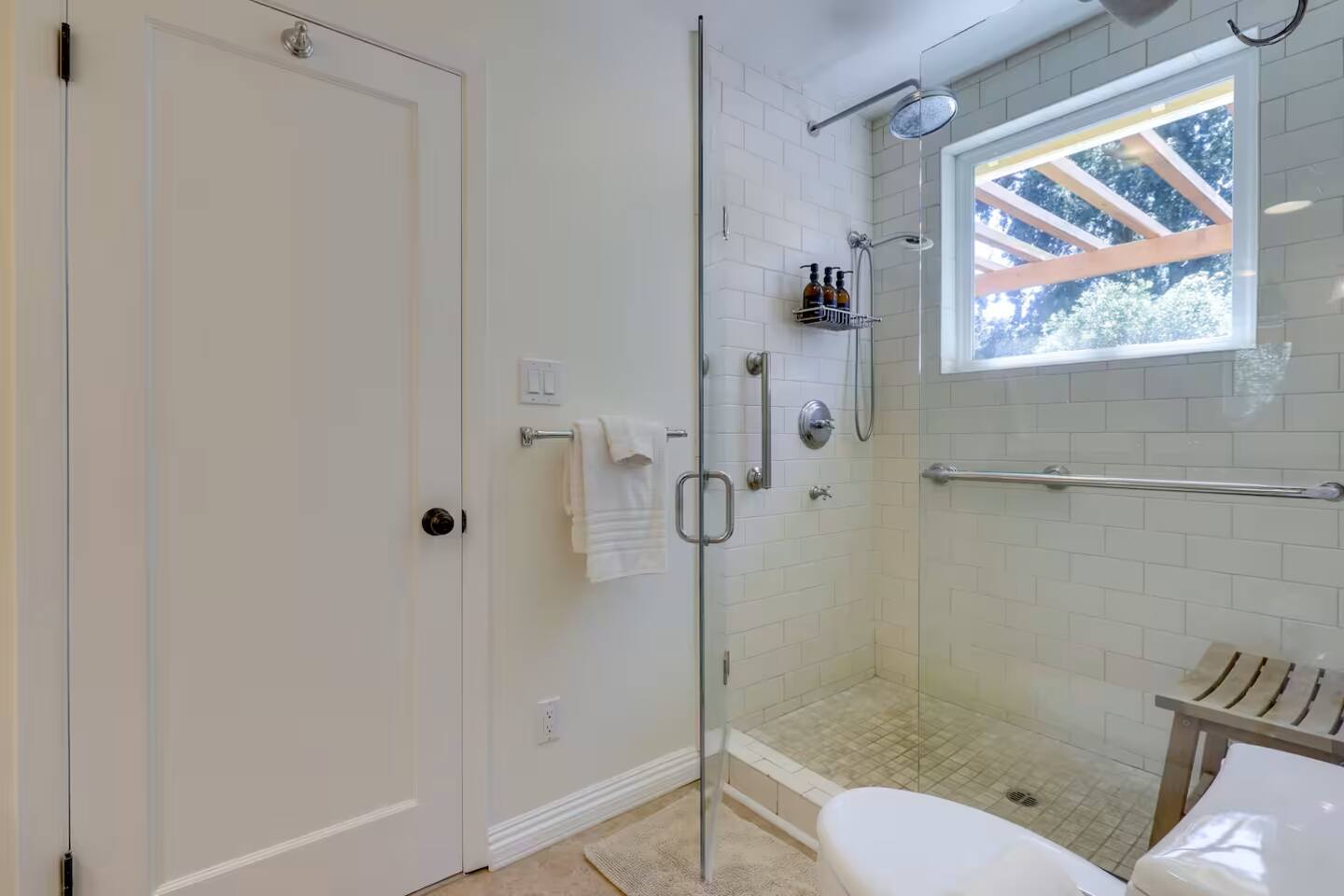 Refresh and unwind in this spacious bathroom featuring a sleek walk-in shower.