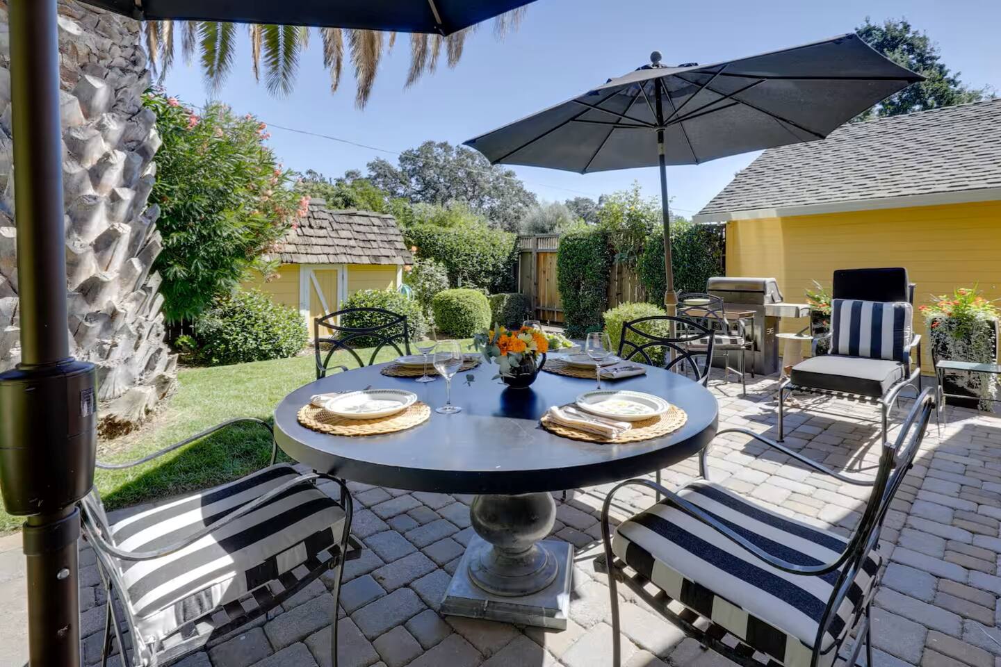 Enjoy alfresco dining in this charming garden seating area, surrounded by nature.