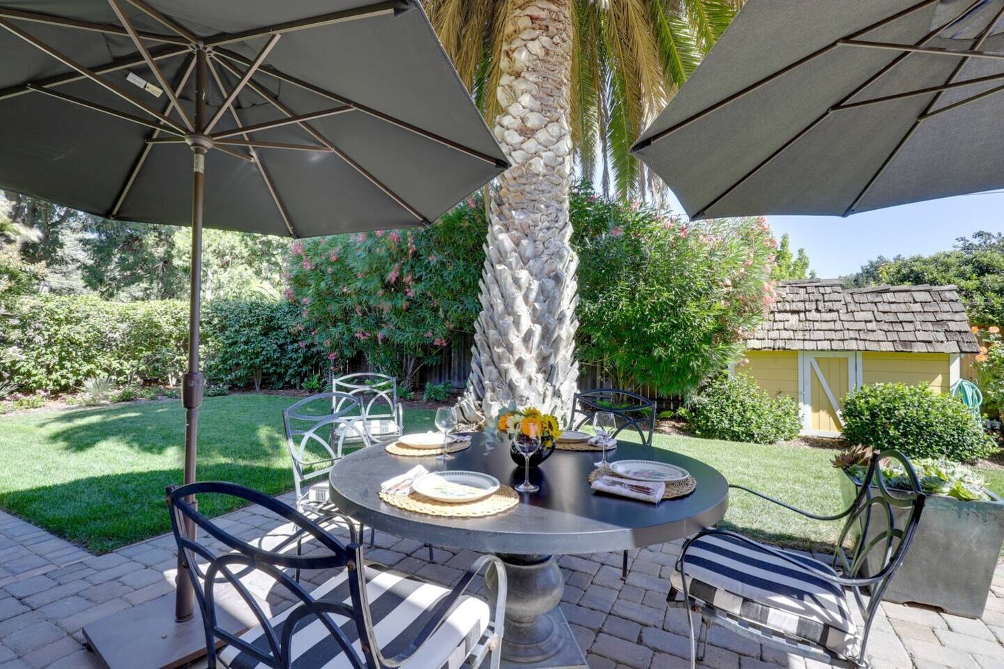 Enjoy alfresco dining in this charming garden seating area, surrounded by nature.