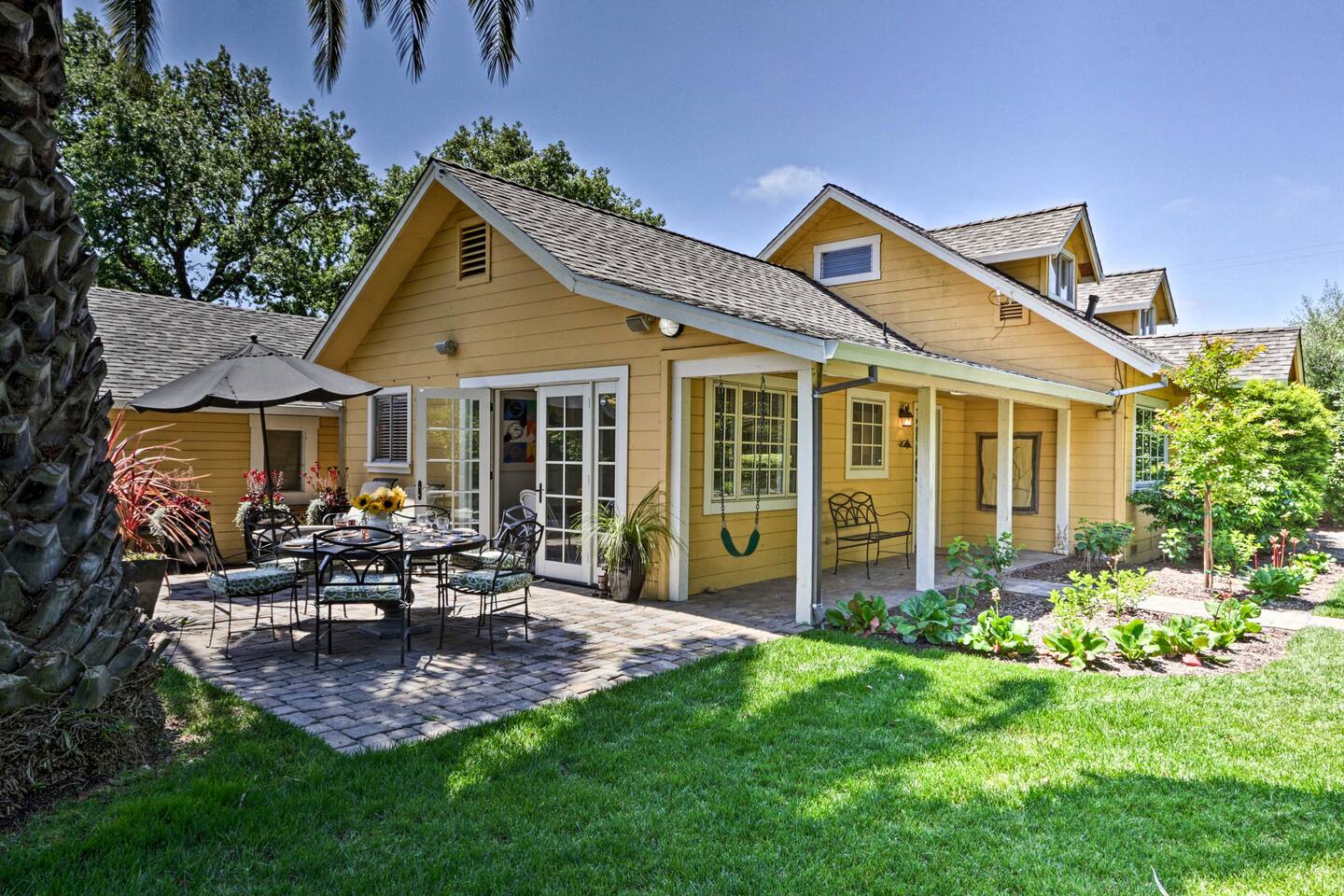 Enjoy alfresco dining in this charming garden seating area, surrounded by nature.