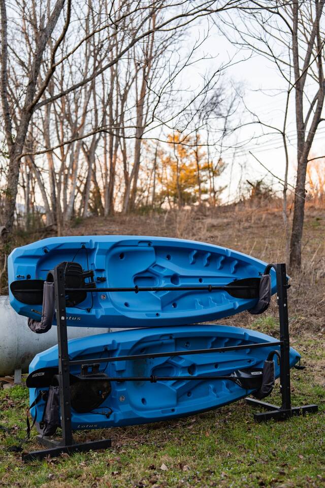 Blue kayaks on a rack, ready to launch