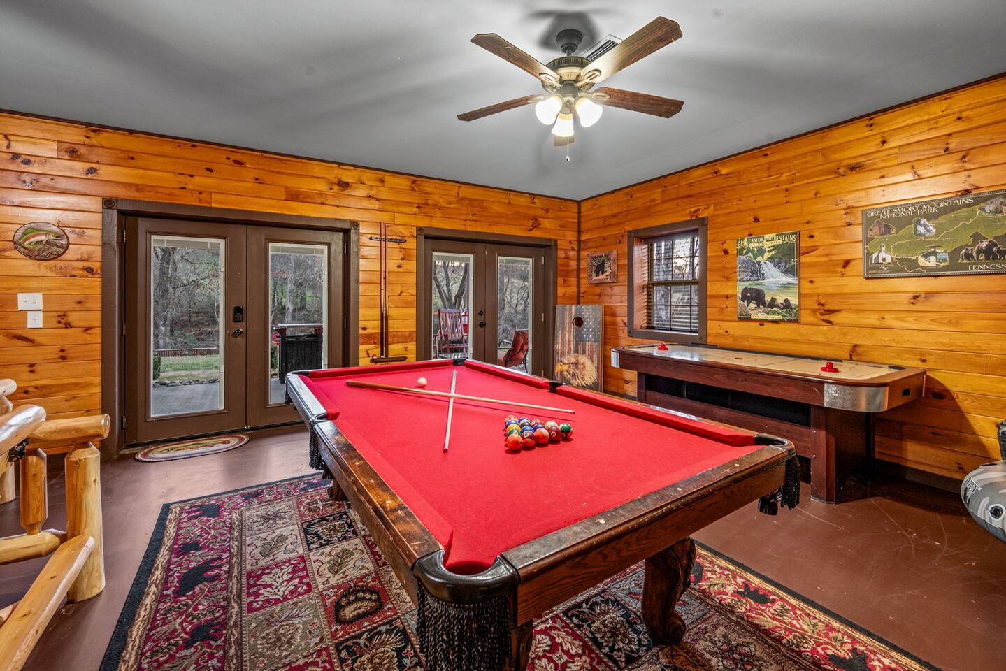 Game room with a red-felt pool table and an air hockey table
