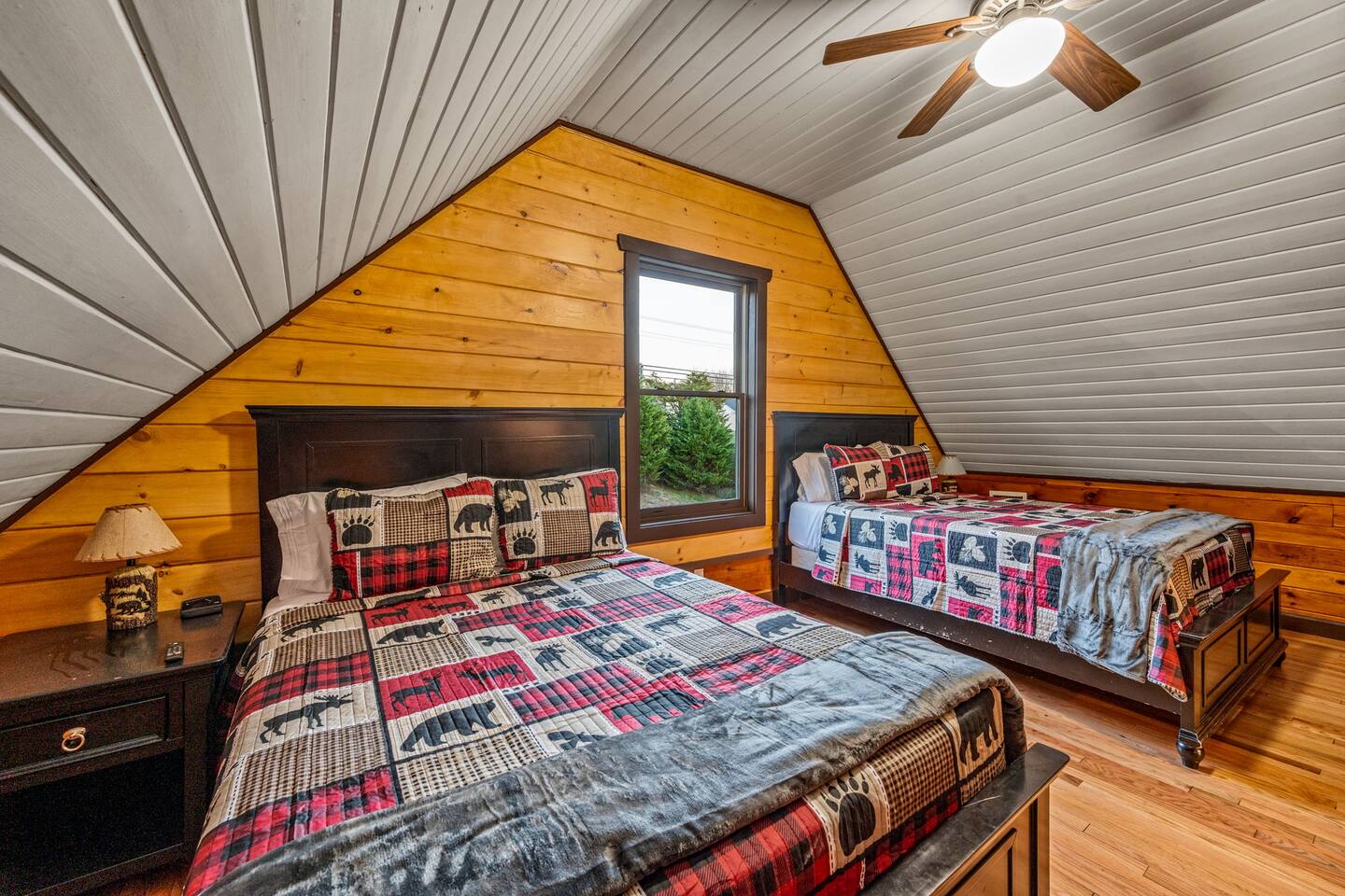 Bedroom with two queen beds and red patchwork quilts