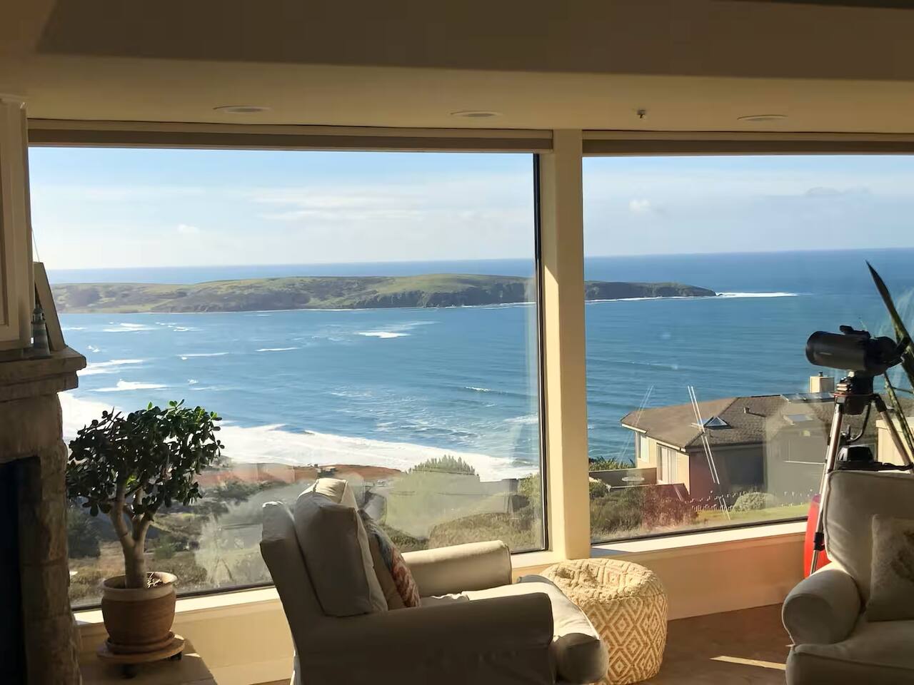 Unwind in this bright and airy living space, where expansive windows invite natural light and provide the perfect spot for stargazing at night.