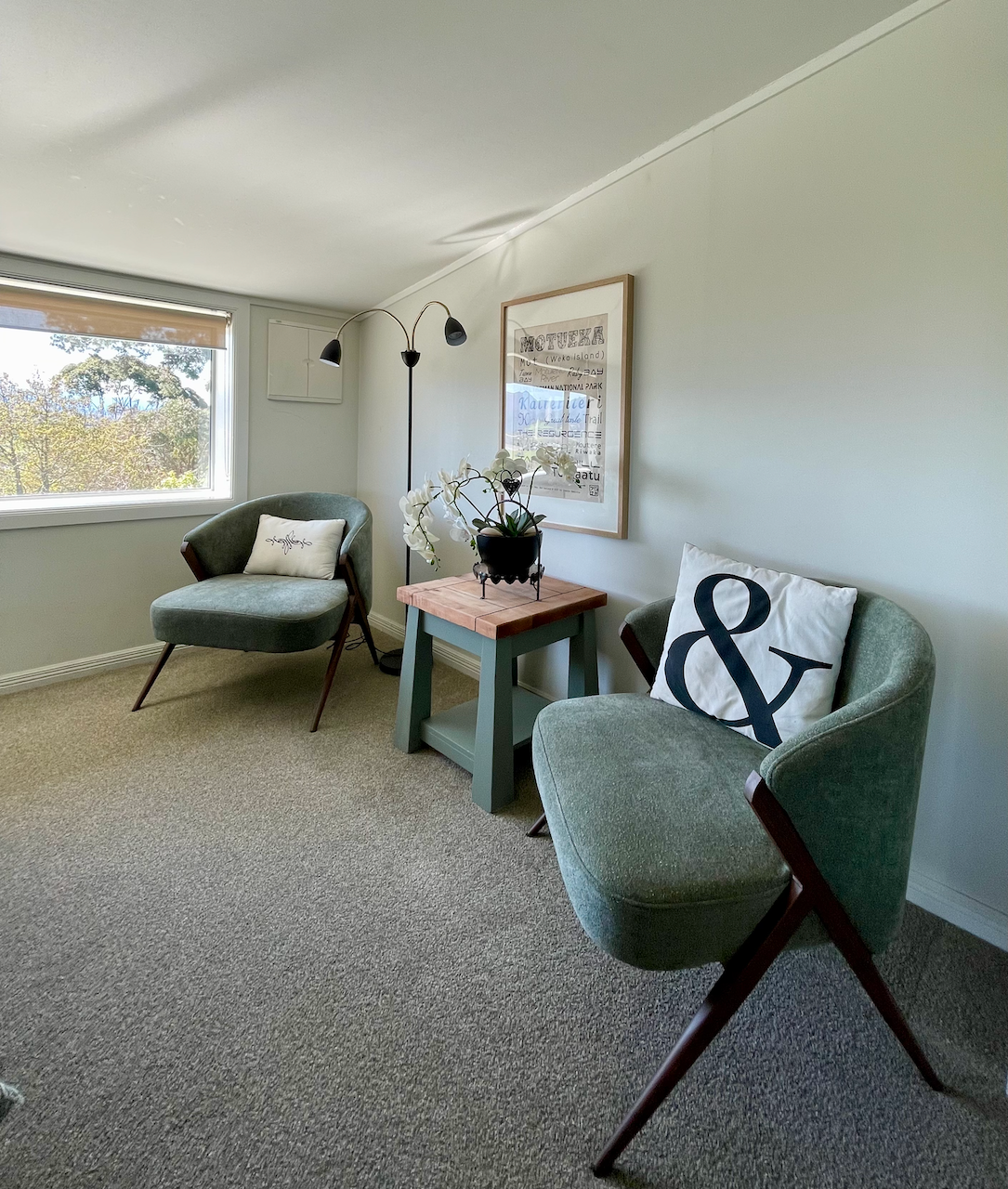 Cozy reading nook with treetop views and stylish mid-century seating