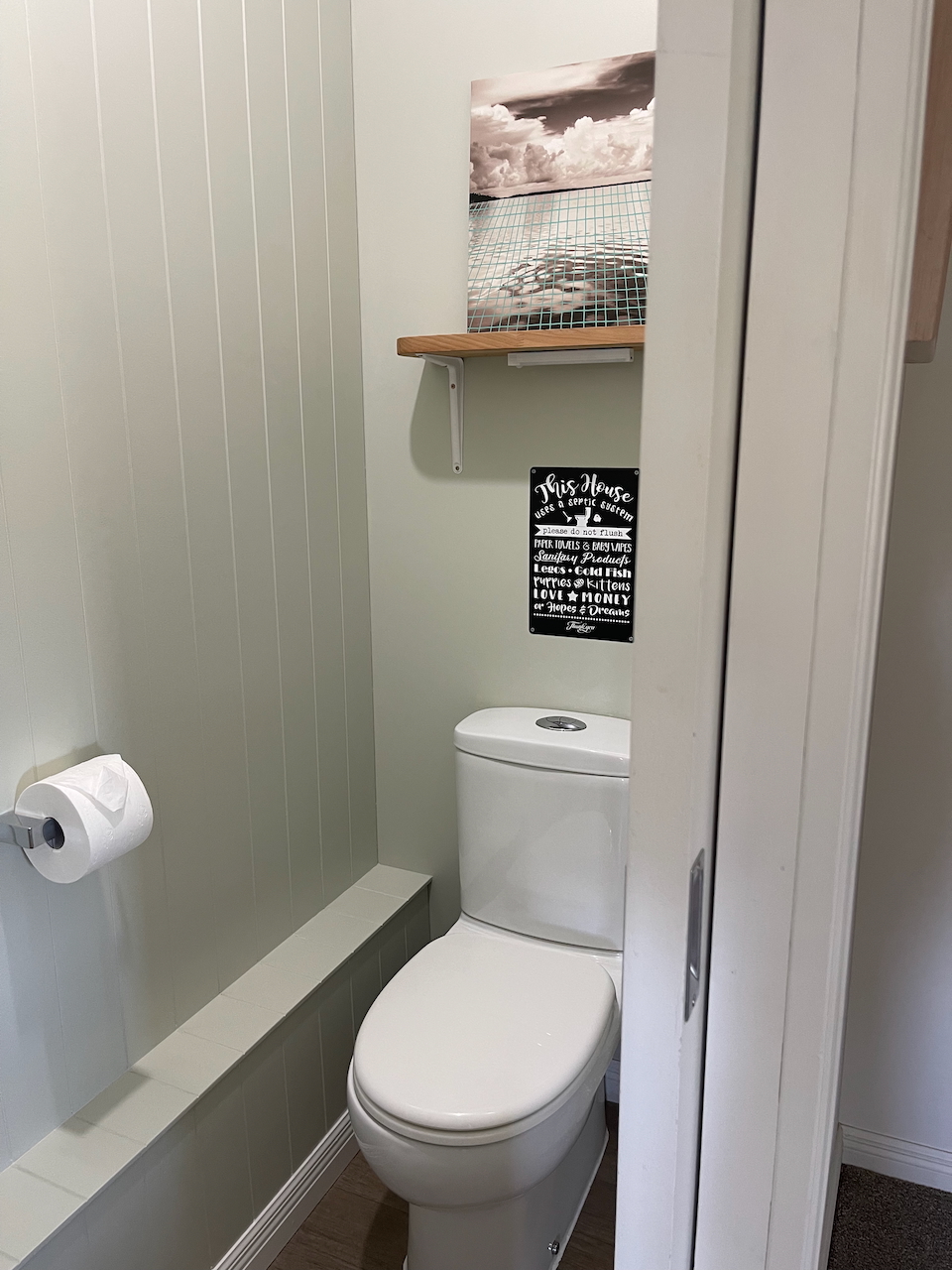 Charming half bath with modern finishes and coastal-inspired decor