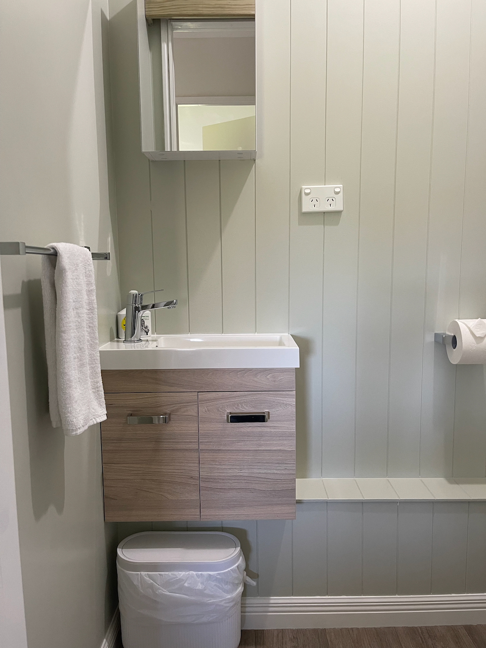 Modern half bathroom, vanity with sleek finishes and clean coastal style