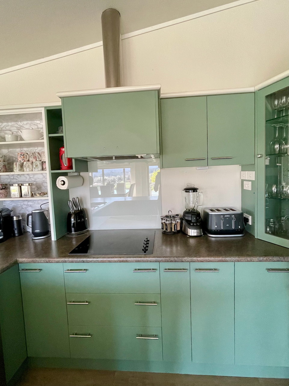 Bright retro-modern kitchen with full appliances and stylish cabinetry