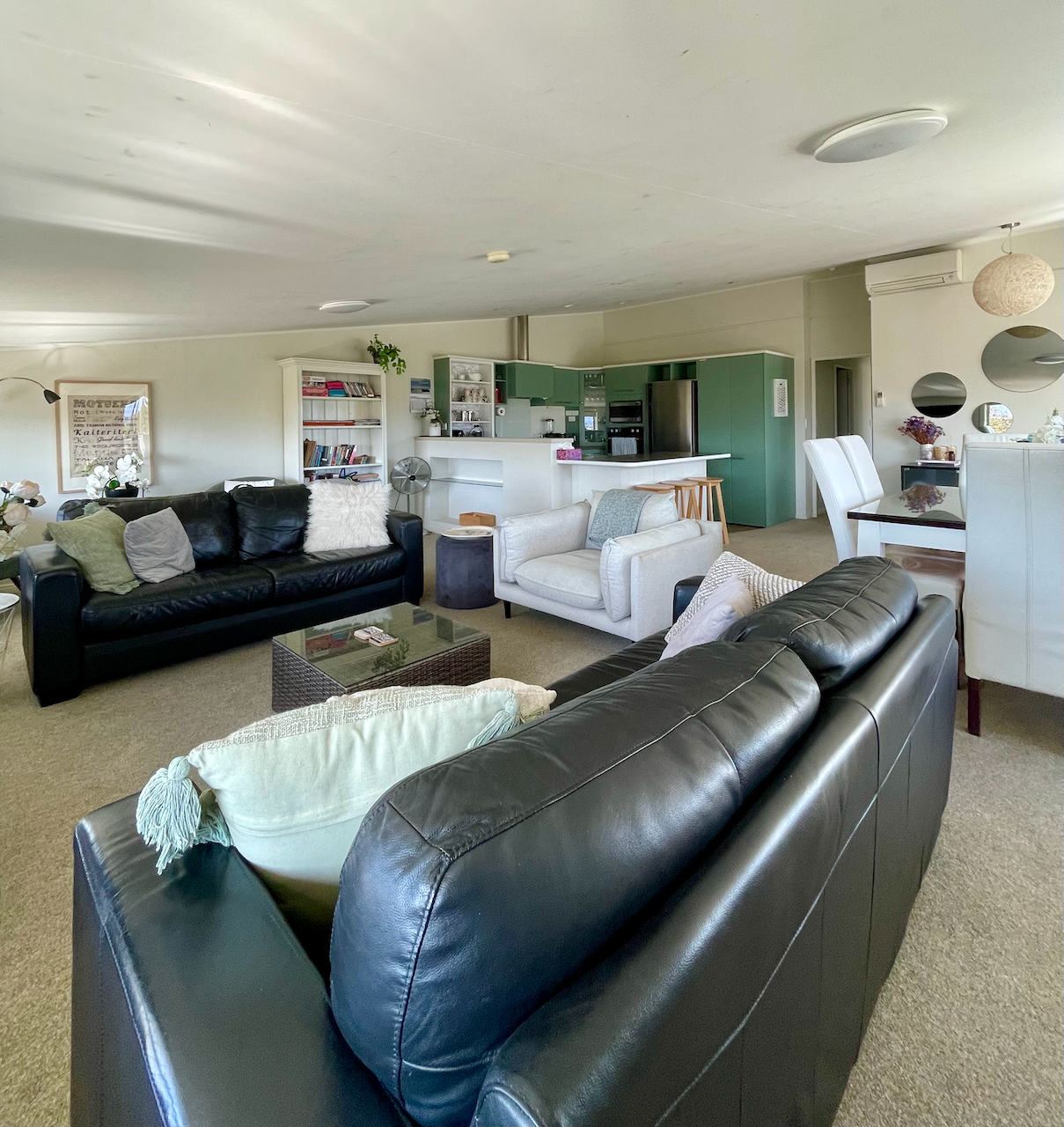 Spacious open-plan lounge with comfy seating and modern kitchen