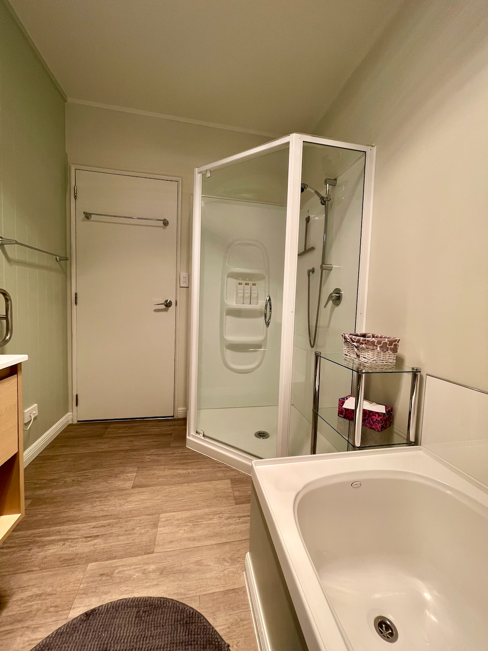 Spacious bathroom with separate shower, bathtub, and warm modern finishes