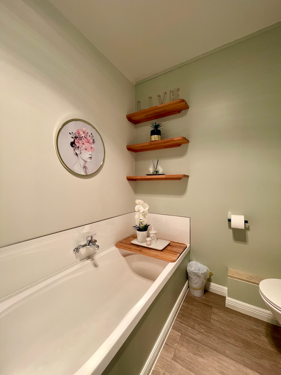 Spa-like bathroom with soaking tub, warm wood accents, and elegant décor