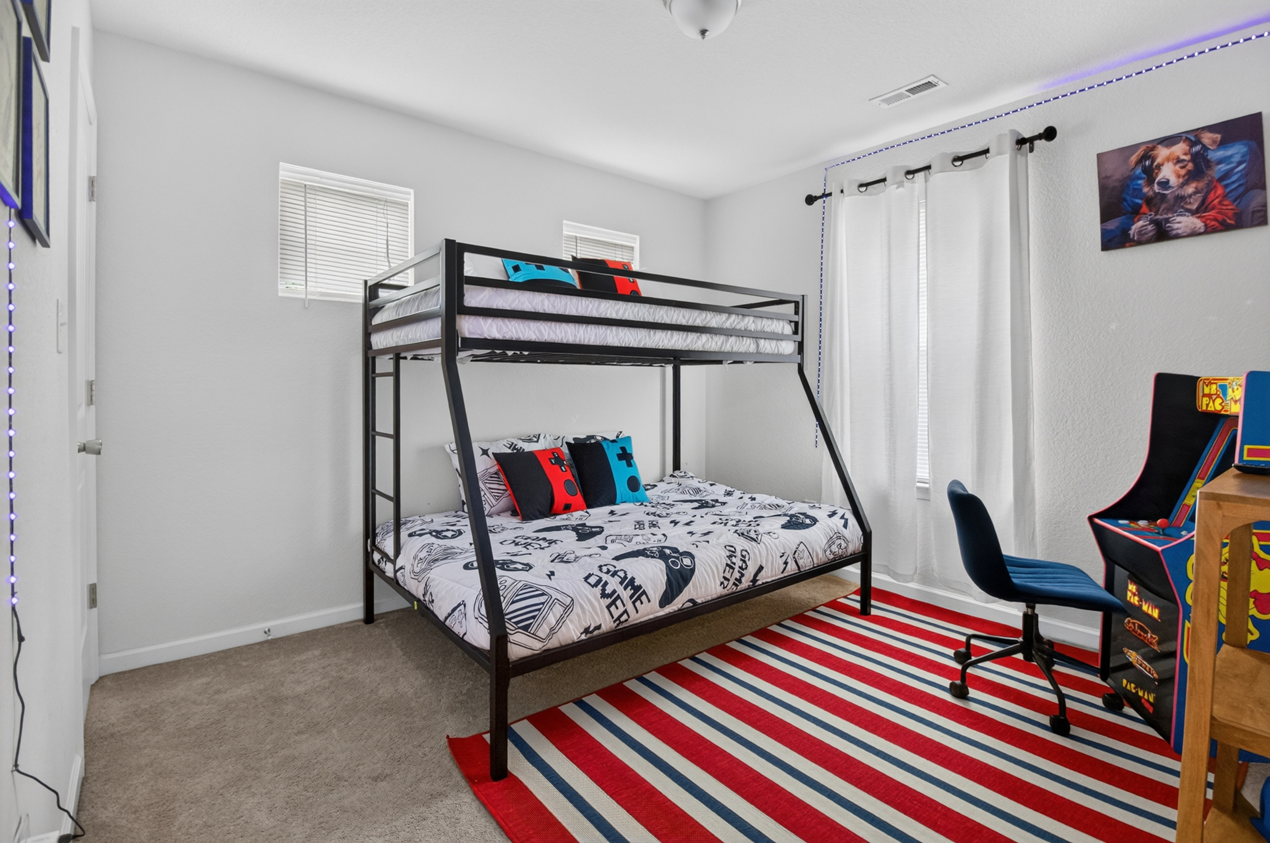 Fun bunk room with arcade game, bold decor, and space for kids or groups