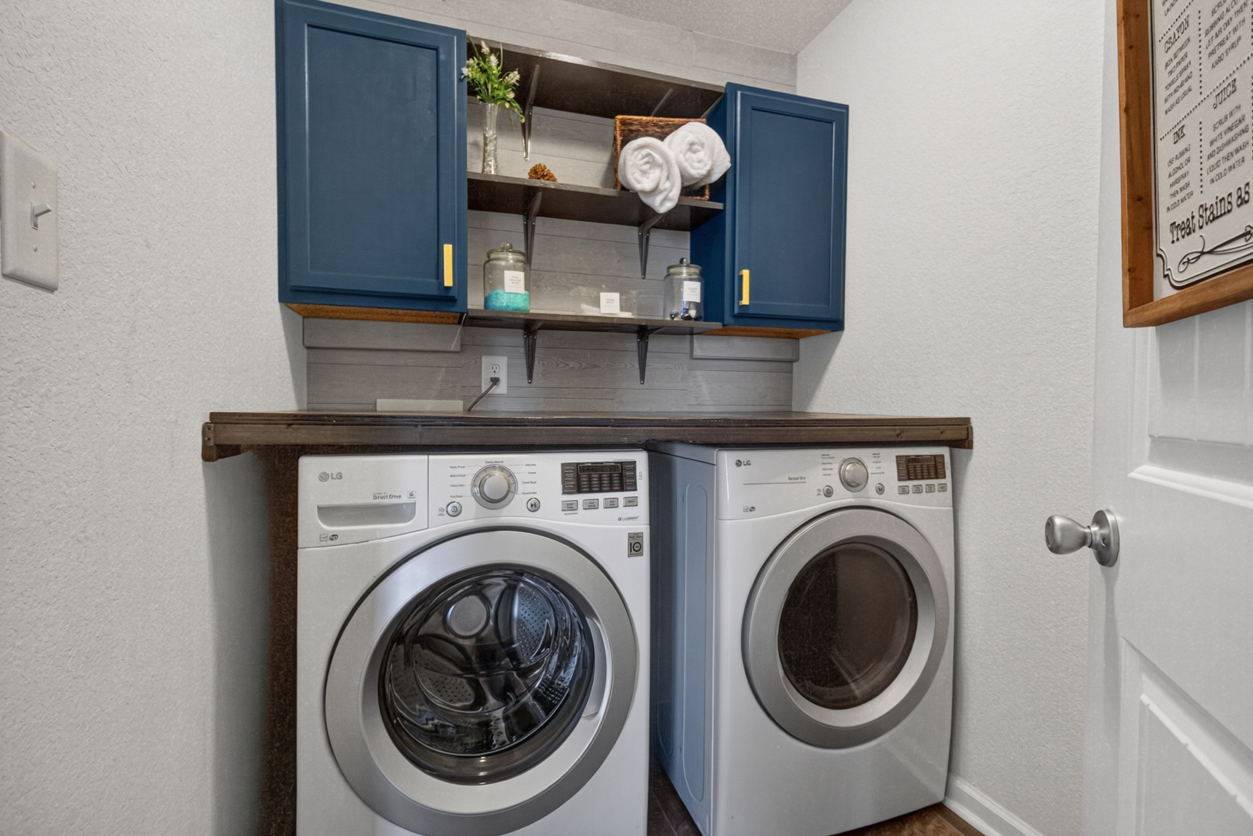Stylish laundry room with front-load washer/dryer and handy storage