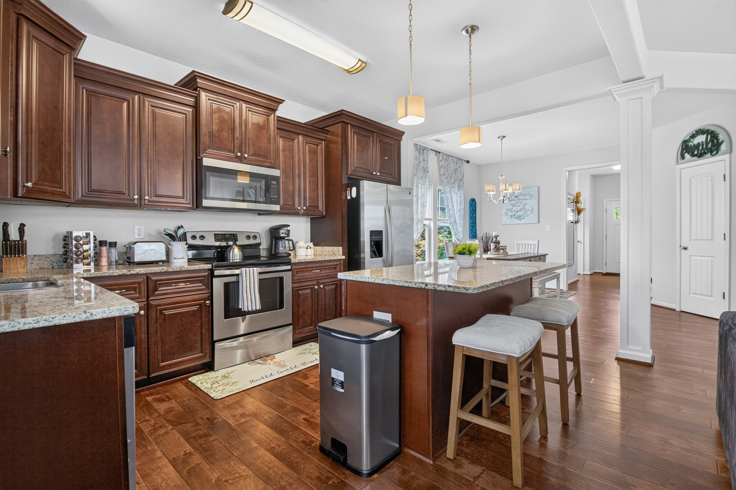 Spacious gourmet kitchen with island seating and stainless appliances