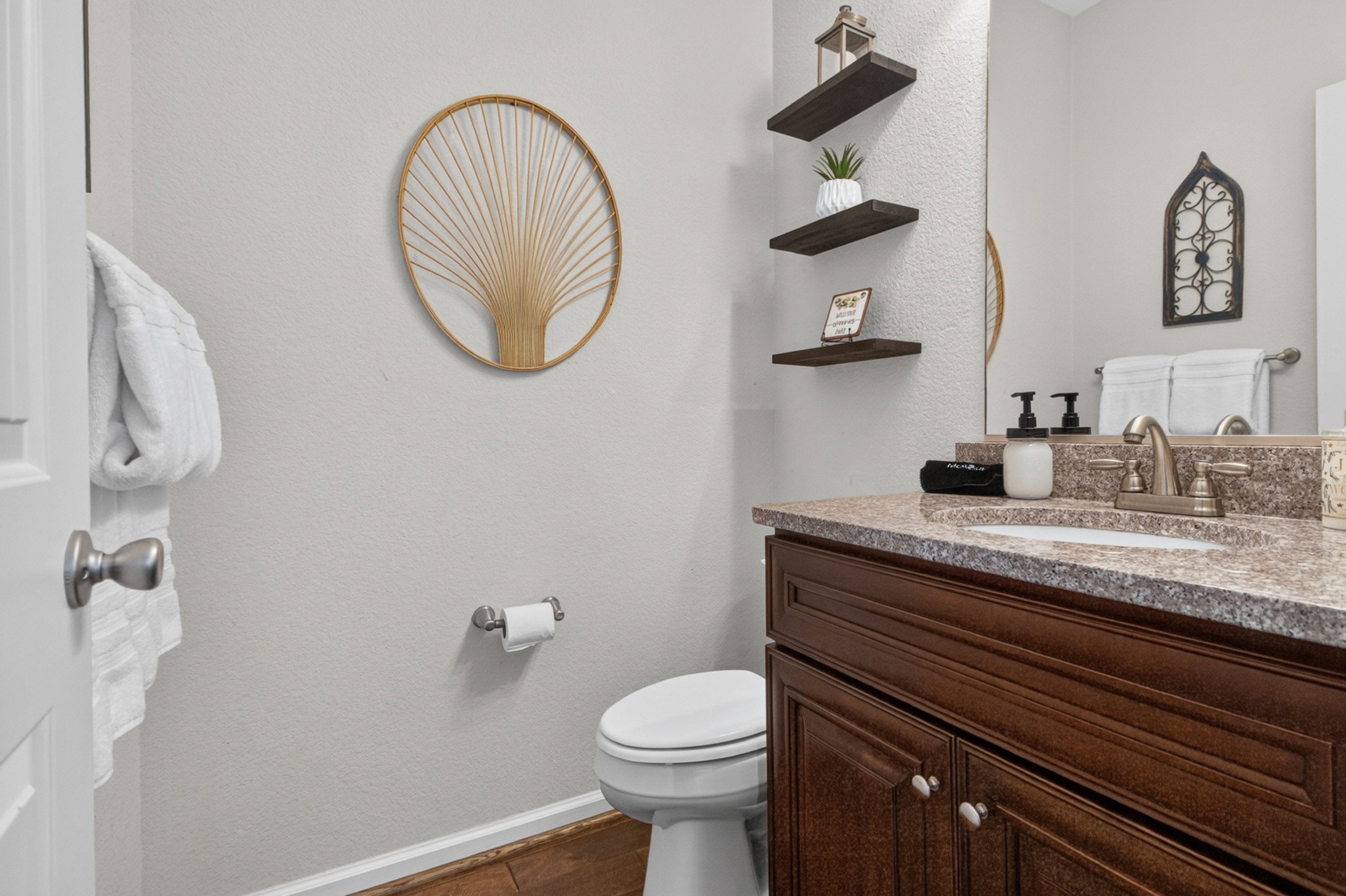 Bright, guest-ready bathroom with stylish décor and warm wood vanity