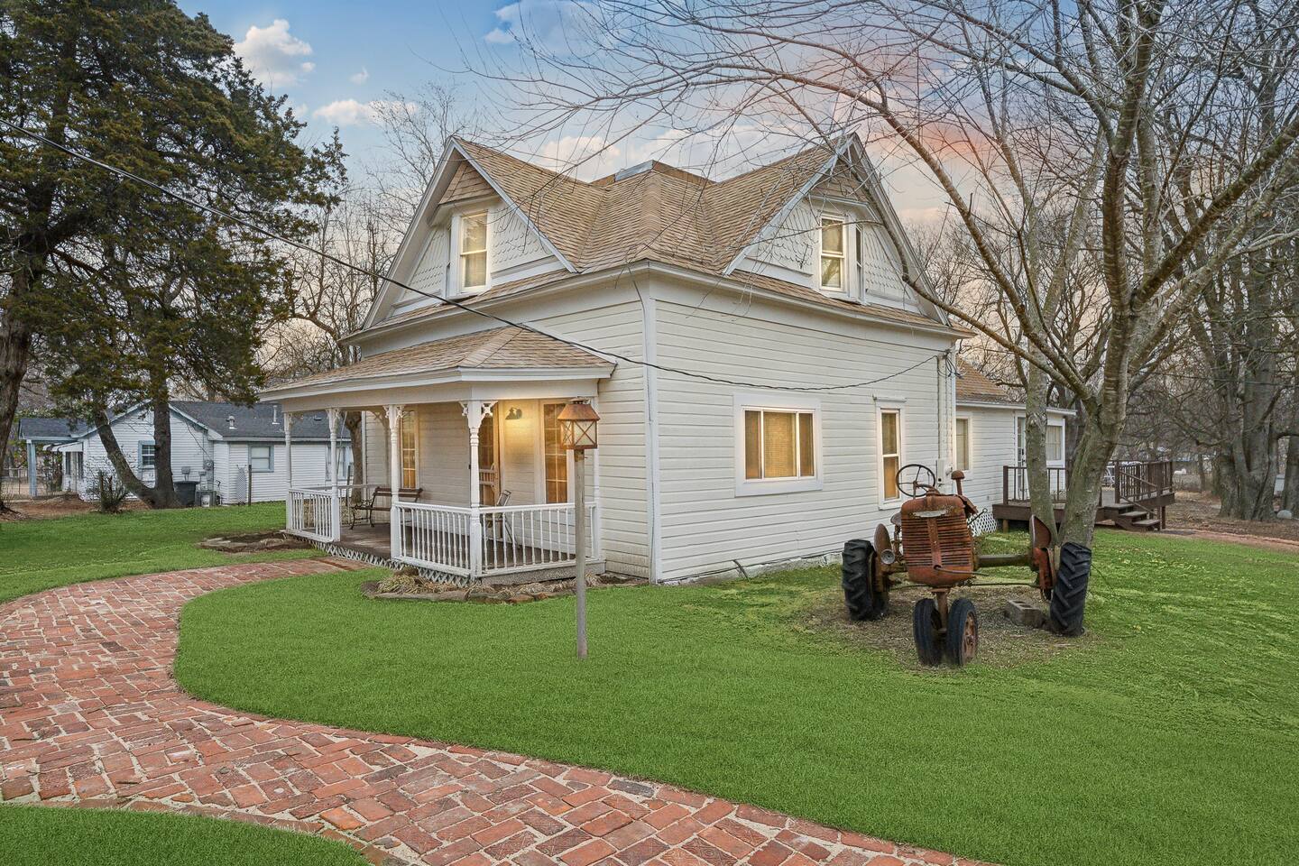 Front porch - Relax on the charming wraparound porch with vintage seating and peaceful country views.