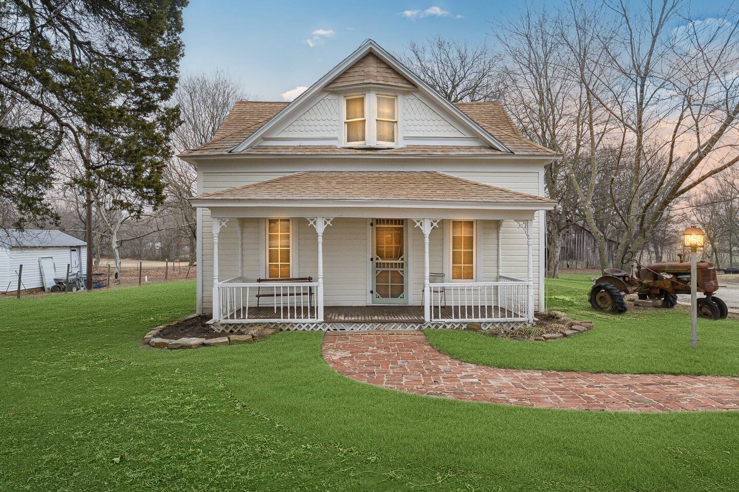 Farm House Exterior - Classic farmhouse with a brick walkway, spacious yard, and historic charm.