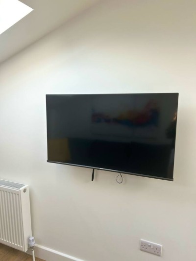 Relaxed living room with TV, couch, and dining area.